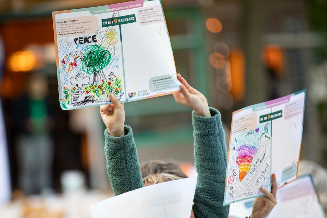 Children holding up their drawings
